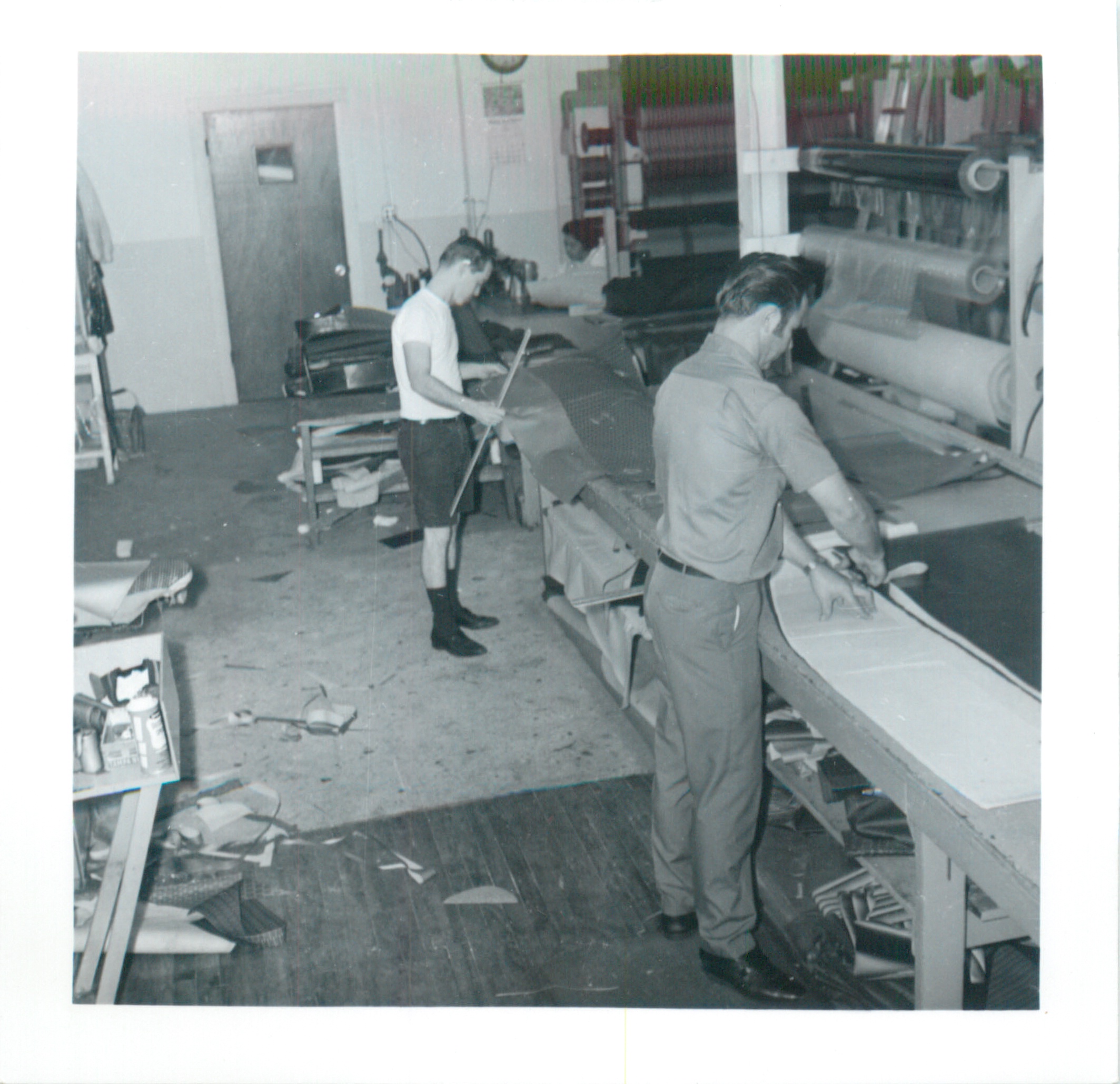 Workers cutting materials in the shop