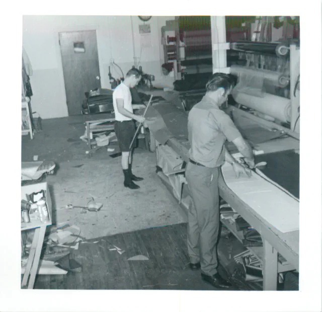 Workers cutting materials in the shop